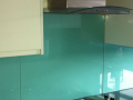 Painted glass kitchen Splashbacks  with electrical cut outs and supporting Hobb decourative glass in Northern ireland.png